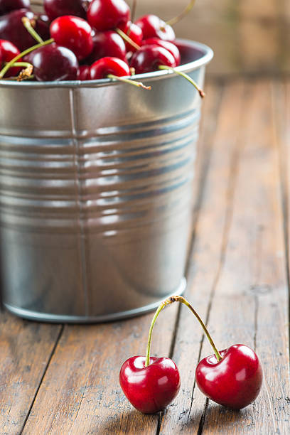 istock Little brass bucket of cherries on a table 498851547