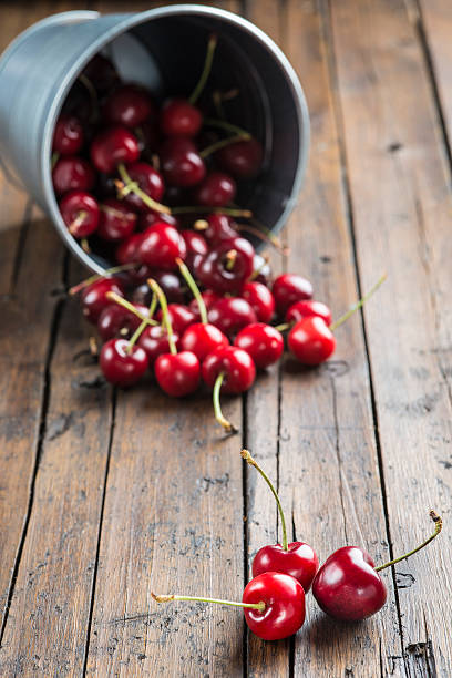 istock Little brass bucket of cherries on a table 498854461