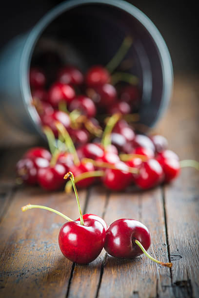 istock Little brass bucket of cherries on a table 498854491
