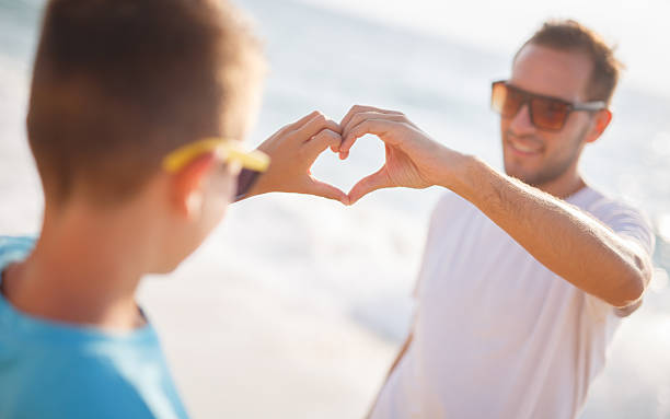 istock Father and son made a heart shape 498856402