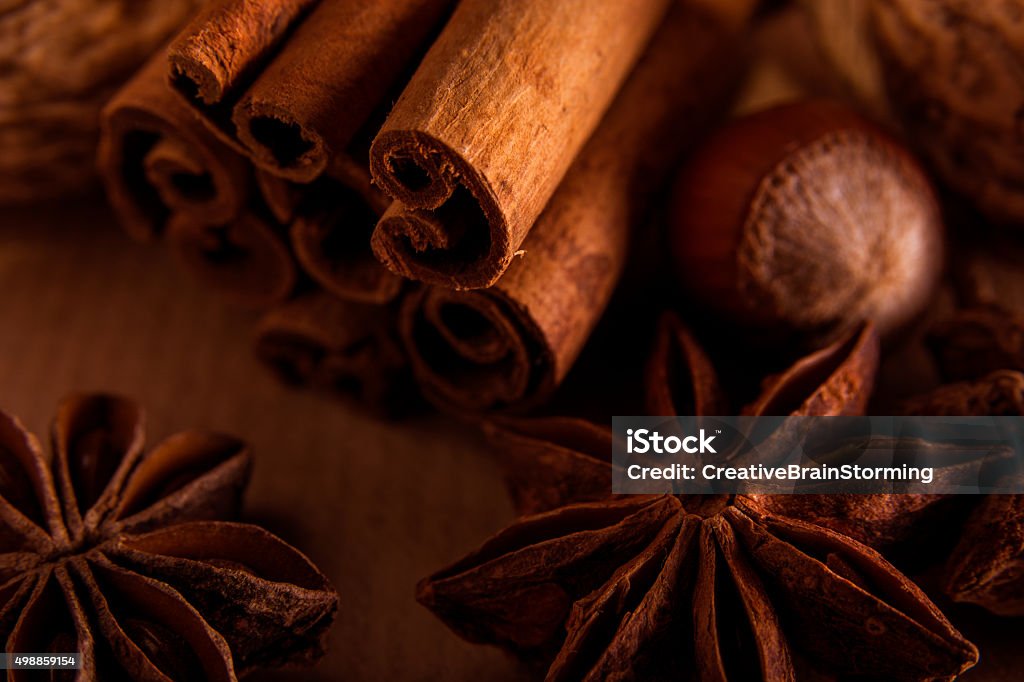 Cinnamon, anise and nuts on a brown background. 2015 Stock Photo