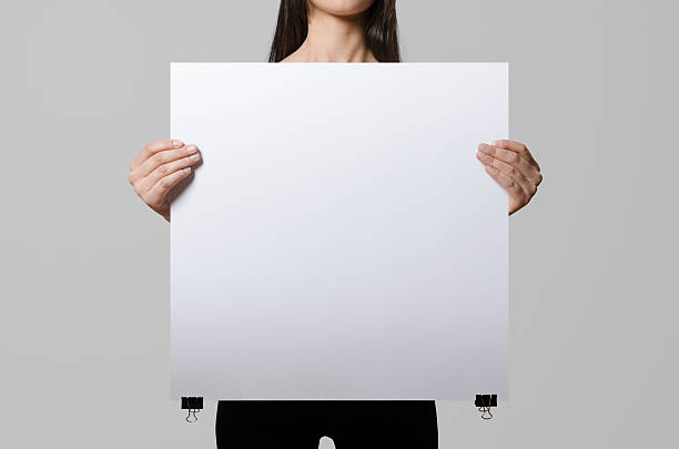 istock Woman holding a blank poster, square 50x50, mock up. 498860088