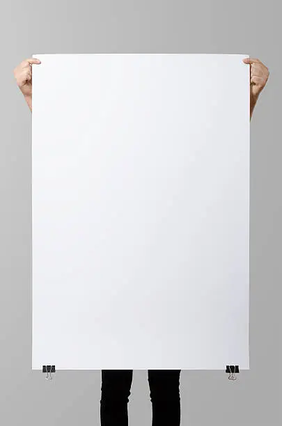 Photo of Woman holding a blank poster, square 70x100, mock up.