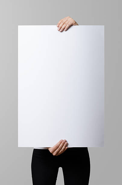 istock Woman holding a blank poster, square 50x70, mock up. 498860312
