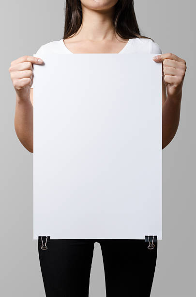 istock Woman holding a blank poster, square 35x50, mock up. 498860498