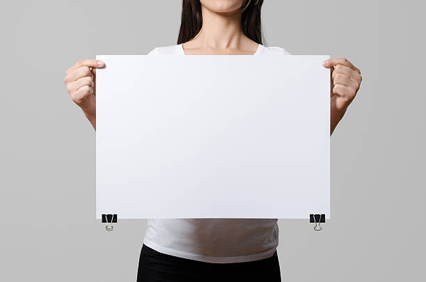 istock Woman holding a blank poster, square 50x35, mock up. 498860734