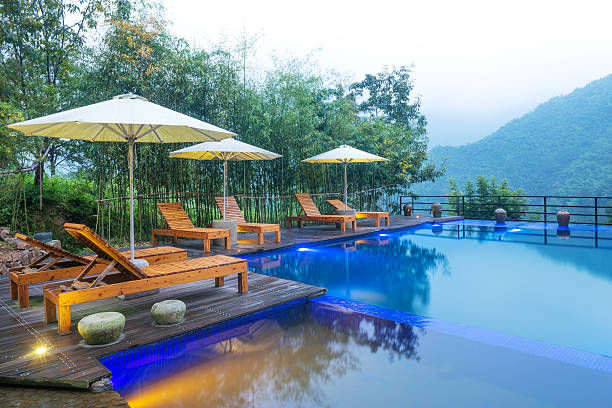 istock Umbrella chair in hotel pool resort with sunset 498863482