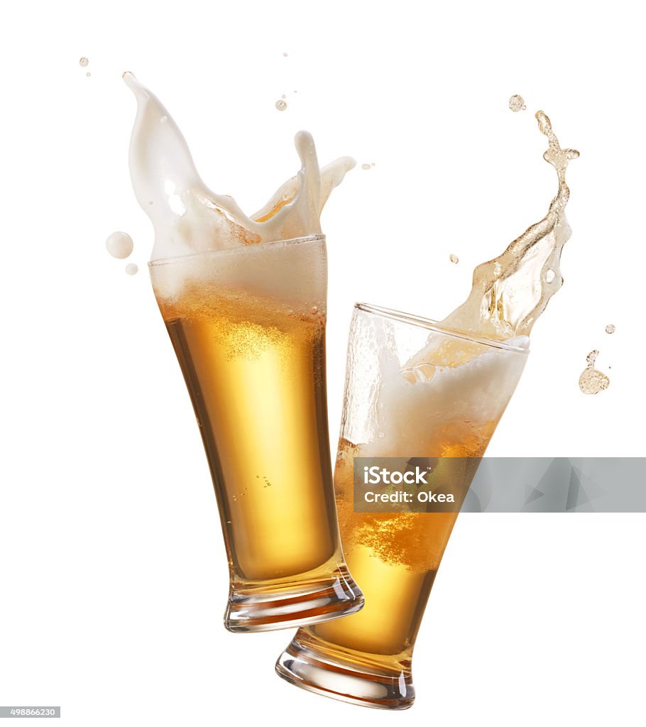 toasting two glasses of beer toasting creating splash Beer - Alcohol Stock Photo