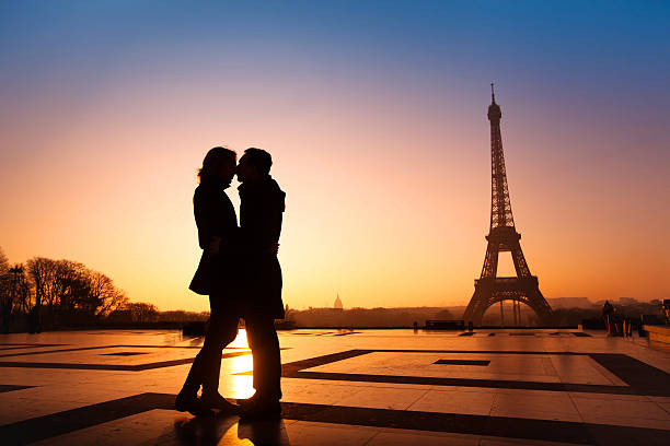 romantic couple in Paris loving couple kissing on Eiffel Tower background, Paris, France paris france eiffel tower love kissing stock pictures, royalty-free photos & images