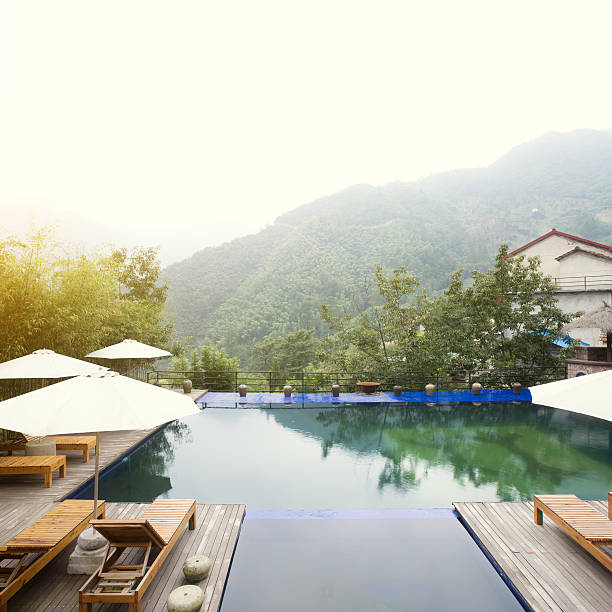 istock Umbrella chair in hotel pool resort with sunset 498867918