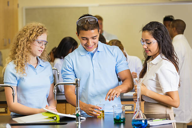 istock High school chemistry students doing experiement together in class 498879157