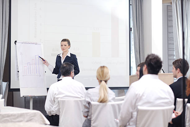 istock business woman giving presentation 498882363