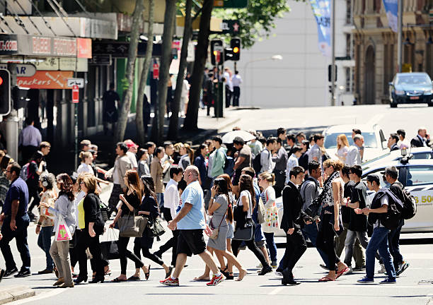 istock People crossing sunlit street 498883644