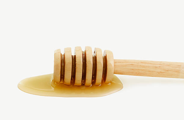istock honey dripping from a wooden honey 498883794