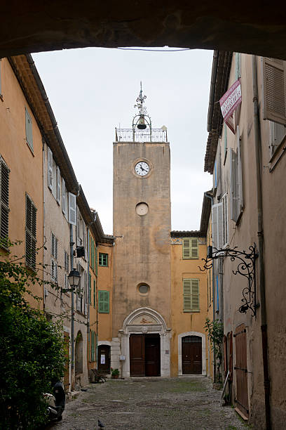 Steeple in Biot Stone bell tower of the medieval village of Biot in Cote d'Azur biot stock pictures, royalty-free photos & images