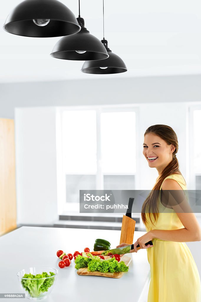 Diet. Healthy Eating Woman Cooking Organic Food. Lifestyle. Diet. Healthy Eating Woman Cooking Fresh Organic Food And Making Vegetable Salad In Kitchen. Healthy Lifestyle Concept. Food Preparation. Nutrition. 2015 Stock Photo