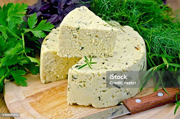 Cheese Round Homemade With Herbs And Knife On Board Stock Photo - Download Image Now