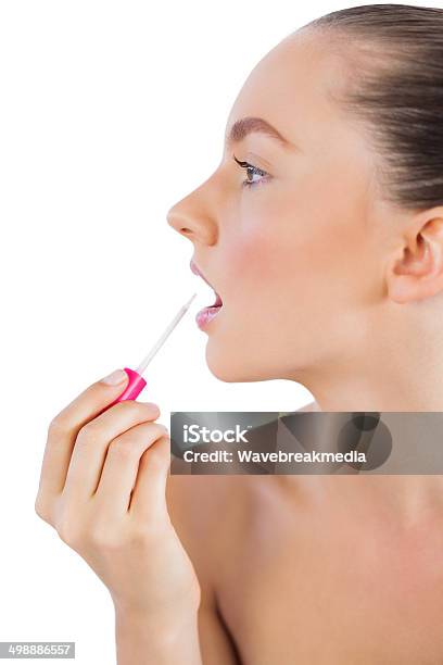 Profile Of Woman Putting Lip Gloss On Her Lips Stock Photo - Download Image Now - Adult, Adults Only, Applying