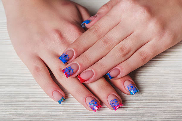 istock French nail art on wooden background 498886736
