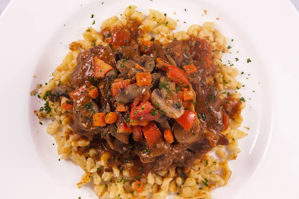 istock Boeuf Bourguignon topped with parmesan cheese, broccoli, parsley, carrot 498886752