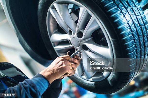 Replacing Car Wheel And Tyre Stock Photo - Download Image Now - Tire - Vehicle Part, Car, Auto Repair Shop