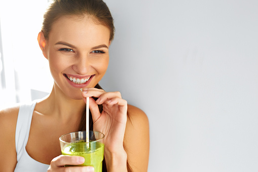 Healthy Food Eating. Happy Beautiful Smiling Woman Drinking Green Detox Vegetable Smoothie. Diet. Healthy Lifestyle, Vegetarian Meal. Drink Juice. Health Care And Beauty Concept.