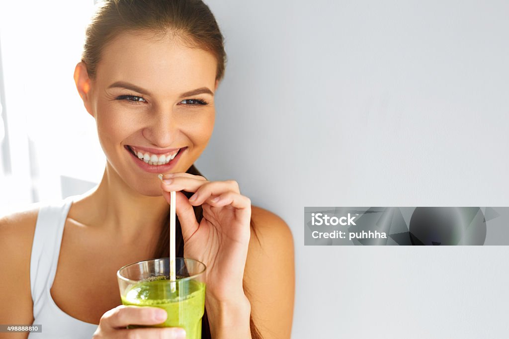 Healthy Food Eating. Woman Drinking Smoothie. Diet. Lifestyle. Nutrition Healthy Food Eating. Happy Beautiful Smiling Woman Drinking Green Detox Vegetable Smoothie. Diet. Healthy Lifestyle, Vegetarian Meal. Drink Juice. Health Care And Beauty Concept. Drinking Stock Photo