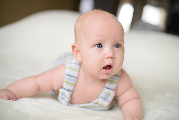 Little baby on the bed stock photo