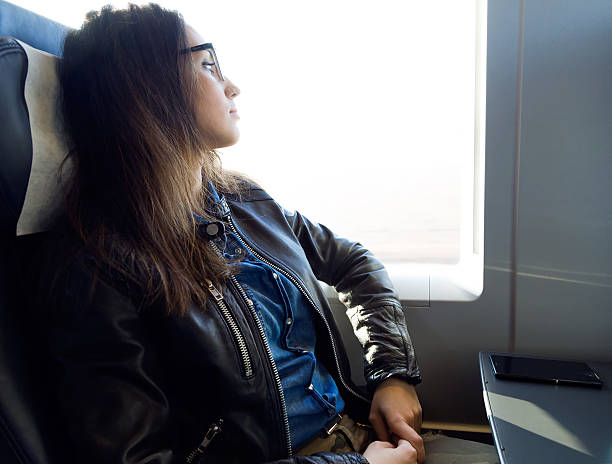 istock Beautiful young woman travelling by train. 498890808