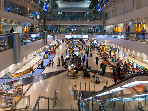Dubai, United Arab Emirates - January 28, 2014: People in shopping centre in hall of terminal of Dubai International Airport