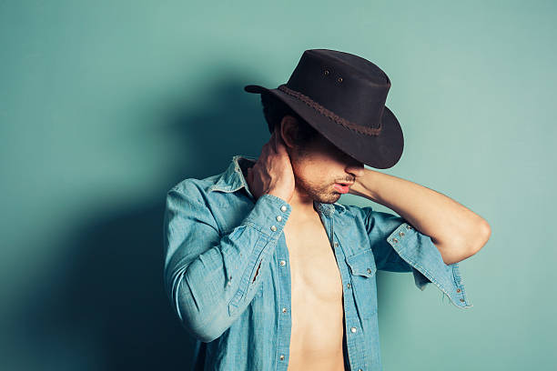 istock Sexy young cowboy with open shirt 498899701
