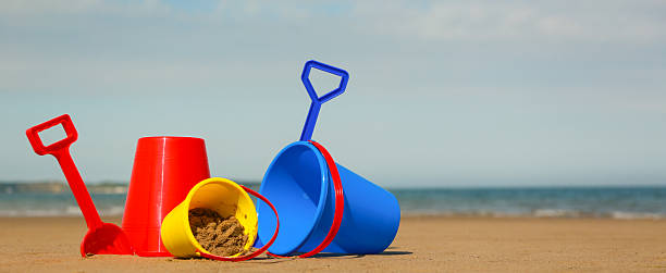istock Beach, sea, buckets, spades and distant boat 498900797