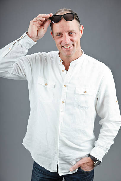 istock Expressive middle aged man wearing white shirt and retro sunglasses. 498901335