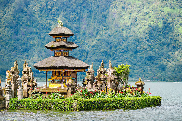 Pura Ulun Danu Bratan Temple on Bali in Indonesia Pura Ulun Danu Bratan is a major Shivaite and water temple on Bali, Indonesia. The temple complex built in 1663 is located on the shores of Lake Bratan in the mountains near Bedugul. floating temple in lake bedugul bali stock pictures, royalty-free photos & images