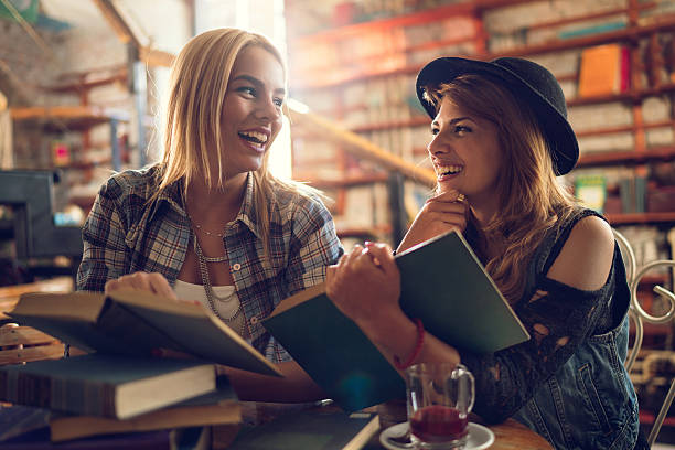 istock Cheerful female students talking to each other in a library. 498906450