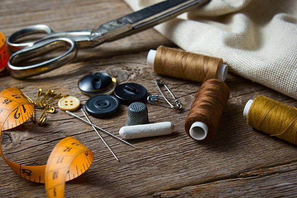 istock Sewing accessories on wooden table 498907454