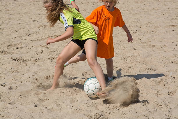 Ahus, Sweden - July 4, 2014: Beach soccer tournament game players on the Tappet beach on a sunny day in July. 