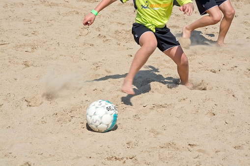 Ahus, Sweden - July 4, 2014: Beach soccer tournament game players on the Tappet beach on a sunny day in July. 