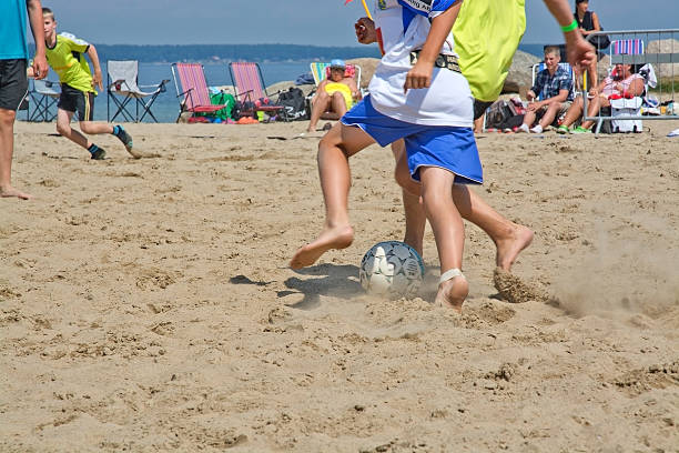 Ahus, Sweden - July 4, 2014: Beach soccer tournament game players on the Tappet beach on a sunny day in July. 