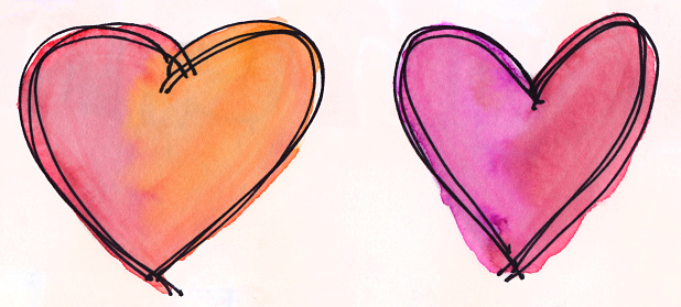Hand painted hearts created with watercolors and ink. There are two hearts with prominent colors of red, orange, and pink. They are outlined in black ink. They are isolated on a white background for copy space. There is a subtle texture in the paint.