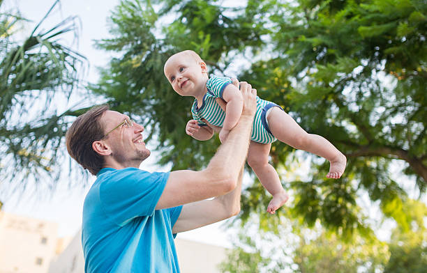 istock Playful father having fun with his baby boy in nature. 498909956
