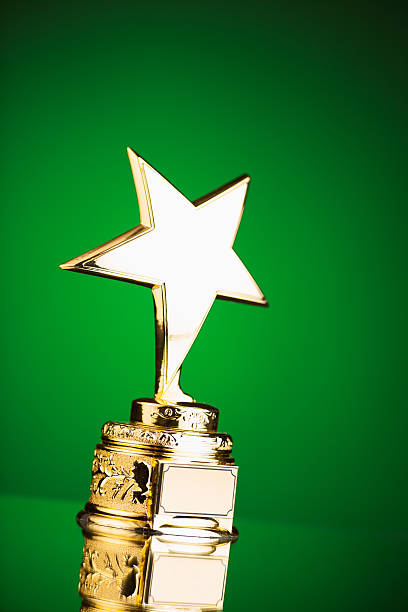 istock gold star trophy on green background 498910350