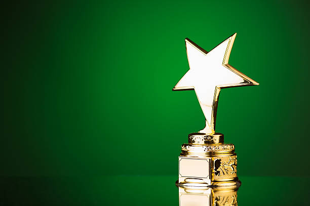 gold star trophy on green background