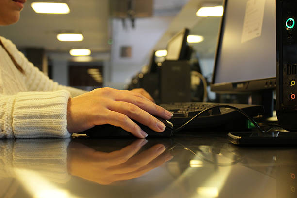istock Young student girl at the PC within the public Library 498910672