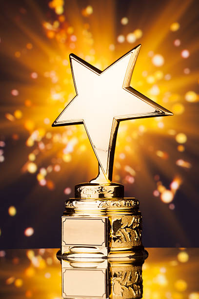 istock gold star trophy against shiny background 498910682