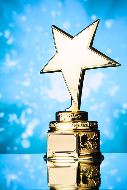 istock gold star trophy against blue background 498910736