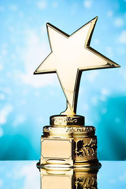 istock gold star trophy against blue background 498910760