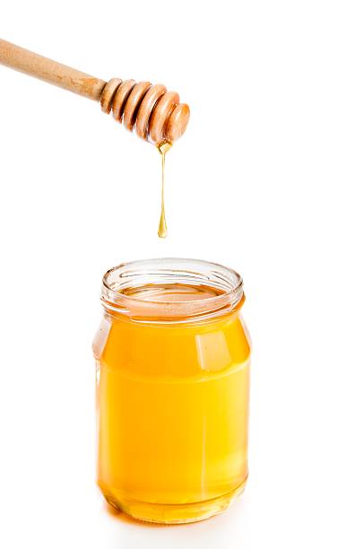 istock opened honey jar on white background with wooden honey dipper 498914028