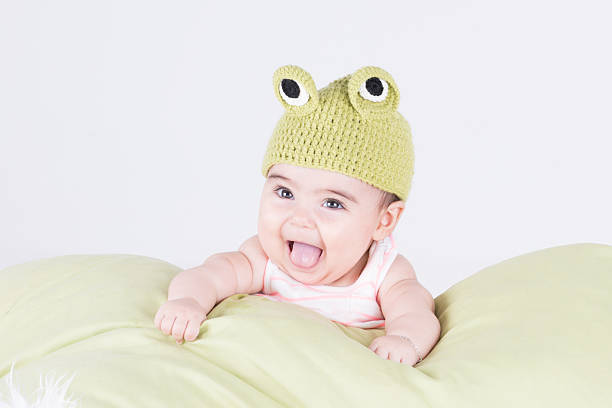 istock Cute little baby with frog cap smiling 498914878
