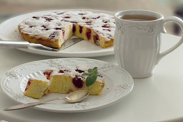 istock Tea in a white mug, a piece of cherry pie 498915570